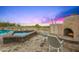 Lush backyard with pool, hot tub, and outdoor fireplace is perfect for relaxing and entertaining at 10325 E Celestial Dr, Scottsdale, AZ 85262