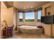 Bathroom featuring a soaking tub surrounded by windows and a desert view at 10325 E Celestial Dr, Scottsdale, AZ 85262