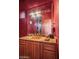 Elegant powder room with gold fixtures, granite counters, and a framed mirror at 10325 E Celestial Dr, Scottsdale, AZ 85262