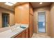 Bathroom featuring built in storage, large vanity, and door to the exterior at 10325 E Celestial Dr, Scottsdale, AZ 85262