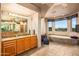 Large bathroom featuring double sinks, large vanity and soaking tub with desert views at 10325 E Celestial Dr, Scottsdale, AZ 85262