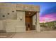 Modern stucco home with covered entrance and manicured desert landscape at 10325 E Celestial Dr, Scottsdale, AZ 85262