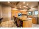 Open concept kitchen features an island with bar seating and wood cabinets at 10325 E Celestial Dr, Scottsdale, AZ 85262