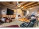 Elegant living room featuring a fireplace, wood beam ceilings and comfortable seating at 10325 E Celestial Dr, Scottsdale, AZ 85262