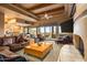 Spacious living room featuring wood beam ceilings, fireplace, and access to the outdoor patio at 10325 E Celestial Dr, Scottsdale, AZ 85262