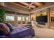 Comfortable main bedroom featuring a sitting area, built-in shelving and desert views at 10325 E Celestial Dr, Scottsdale, AZ 85262