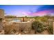 Inviting outdoor pool area featuring a cozy seating area and desert landscaping at 10325 E Celestial Dr, Scottsdale, AZ 85262