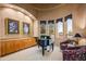 Relax in this cozy sitting room with built-in cabinets, decor and ample natural light at 10325 E Celestial Dr, Scottsdale, AZ 85262