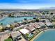 Scenic aerial view of beautiful homes bordering a community lake with lush green landscaping and a neighborhood bridge at 10816 W Palm Ln, Avondale, AZ 85392