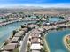 Aerial view showing homes on a serene lake with lush landscaping and mountain views at 10816 W Palm Ln, Avondale, AZ 85392