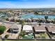 Stunning aerial view of waterfront homes with a community lake and lush landscaping under a clear blue sky at 10816 W Palm Ln, Avondale, AZ 85392