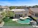 Aerial view showcasing a private backyard with a unique pool, green turf, and a fenced perimeter for privacy at 10816 W Palm Ln, Avondale, AZ 85392