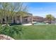 Serene backyard featuring a well-maintained lawn, custom pool, and covered patio area at 10816 W Palm Ln, Avondale, AZ 85392