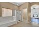 Bathroom showcasing a soaking tub, separate glass shower, and tile flooring at 10816 W Palm Ln, Avondale, AZ 85392