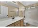 Clean bathroom with a large vanity, shower-tub combo, and neutral color scheme at 10816 W Palm Ln, Avondale, AZ 85392