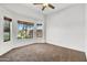 Bright bedroom featuring natural light from the bay windows and a ceiling fan at 10816 W Palm Ln, Avondale, AZ 85392