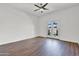 Spacious bedroom with hardwood floors, a ceiling fan, and French doors leading to an outdoor space at 10816 W Palm Ln, Avondale, AZ 85392