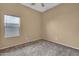 Neutral bedroom features carpet and a large window with blinds at 10816 W Palm Ln, Avondale, AZ 85392