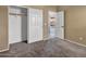 Neutral bedroom showcasing closet space and access to the outdoor patio at 10816 W Palm Ln, Avondale, AZ 85392