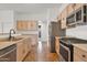 Bright kitchen with stainless steel appliances, gas cooktop, and tile flooring at 10816 W Palm Ln, Avondale, AZ 85392