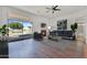 Stylish living room featuring a fireplace, modern sofa, and view of the pool at 10816 W Palm Ln, Avondale, AZ 85392