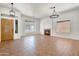 Inviting living room featuring a cozy fireplace and an elegant chandelier at 10816 W Palm Ln, Avondale, AZ 85392