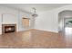 Living room showcasing a fireplace, tiled floors, and an archway at 10816 W Palm Ln, Avondale, AZ 85392