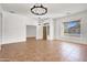 Bright living room featuring tiled floors and a large window at 10816 W Palm Ln, Avondale, AZ 85392