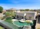 Backyard oasis featuring a private pool, landscaped green space, and a contemporary outdoor living area at 10816 W Palm Ln, Avondale, AZ 85392