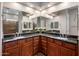 Bright bathroom featuring dual sinks, granite counters, and decorative mirrors at 1163 E Holbrook St, Gilbert, AZ 85298