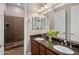 Bright bathroom showcasing a double vanity, granite counters, and tiled shower at 1163 E Holbrook St, Gilbert, AZ 85298