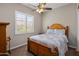 Cozy bedroom filled with natural light, featuring a ceiling fan and carpet at 1163 E Holbrook St, Gilbert, AZ 85298