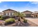 A well maintained single story home with mature landscaping and brick accents on the facade and driveway at 1163 E Holbrook St, Gilbert, AZ 85298