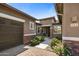 A front view of a single story home with a well maintained front yard and brick accents on the columns at 1163 E Holbrook St, Gilbert, AZ 85298