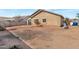 Spacious backyard featuring desert landscaping, a concrete patio, and a stucco home exterior at 11669 N 165Th Ave, Surprise, AZ 85388