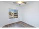 Cozy bedroom has hardwood floors, ceiling fan, and a window view at 11669 N 165Th Ave, Surprise, AZ 85388