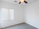 Bright bedroom featuring a ceiling fan, window with blinds, and neutral carpet at 11669 N 165Th Ave, Surprise, AZ 85388