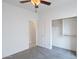 Bedroom with a ceiling fan, closet, open door to hallway, and neutral carpet at 11669 N 165Th Ave, Surprise, AZ 85388