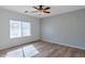 Bedroom with a ceiling fan, window with blinds, and wood-look flooring at 11669 N 165Th Ave, Surprise, AZ 85388