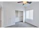 Bedroom with ceiling fan, closet, and a window with blinds at 11669 N 165Th Ave, Surprise, AZ 85388