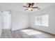 Bright bedroom featuring wood-look flooring and a window with blinds at 11669 N 165Th Ave, Surprise, AZ 85388