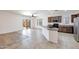 Open kitchen features tile flooring, an island, and stainless steel appliances at 11669 N 165Th Ave, Surprise, AZ 85388