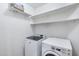 Laundry room featuring a modern washer and dryer and ample shelving above at 11669 N 165Th Ave, Surprise, AZ 85388