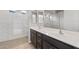 Bathroom featuring double sinks, modern fixtures, and a walk-in shower at 13512 W Copperleaf Ln, Peoria, AZ 85383