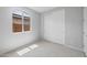Bedroom featuring sliding closet doors, neutral carpet, and a bright window at 13512 W Copperleaf Ln, Peoria, AZ 85383