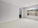 Spacious carpeted bedroom with a large window and ensuite bathroom at 13512 W Copperleaf Ln, Peoria, AZ 85383