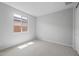 Neutral bedroom featuring carpet, a window, and white walls, ideal for relaxation at 13512 W Copperleaf Ln, Peoria, AZ 85383