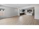 Spacious living room seamlessly connecting to the modern kitchen with dark cabinetry at 13512 W Copperleaf Ln, Peoria, AZ 85383