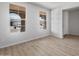 Bright, empty room with wood-look floors and large windows offering great natural light at 13512 W Copperleaf Ln, Peoria, AZ 85383