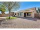 Low maintenance backyard featuring desert landscaping and a covered patio at 13536 W Peck Dr, Litchfield Park, AZ 85340